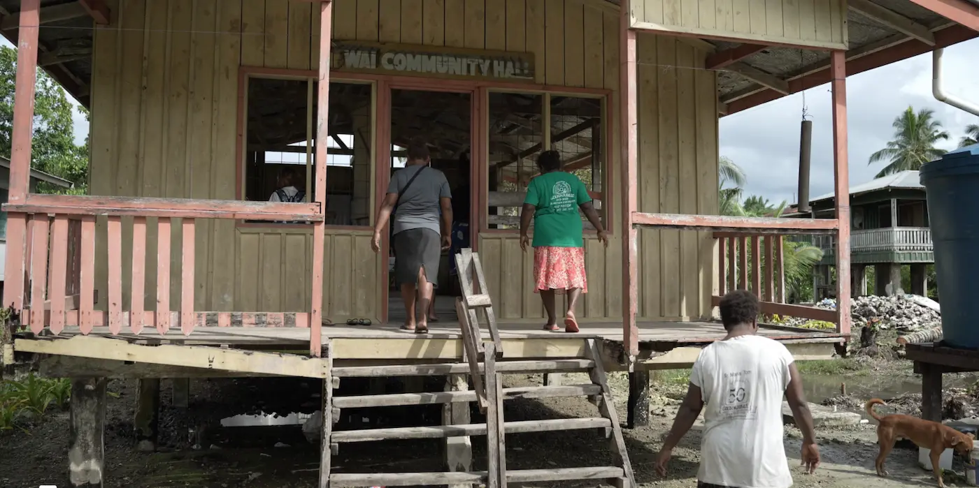 People entering community hall